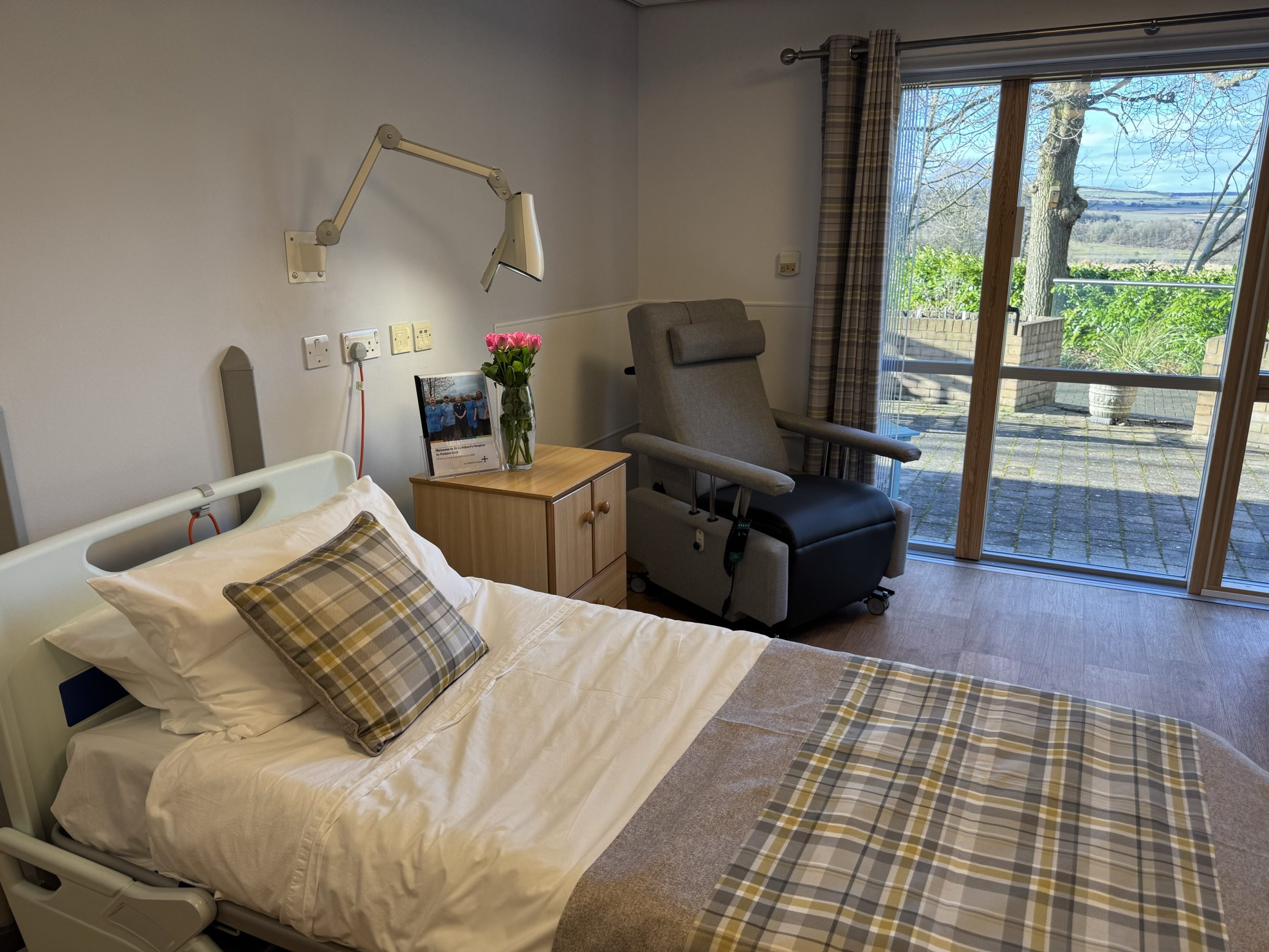 Bedroom with large floor to ceiling window and door