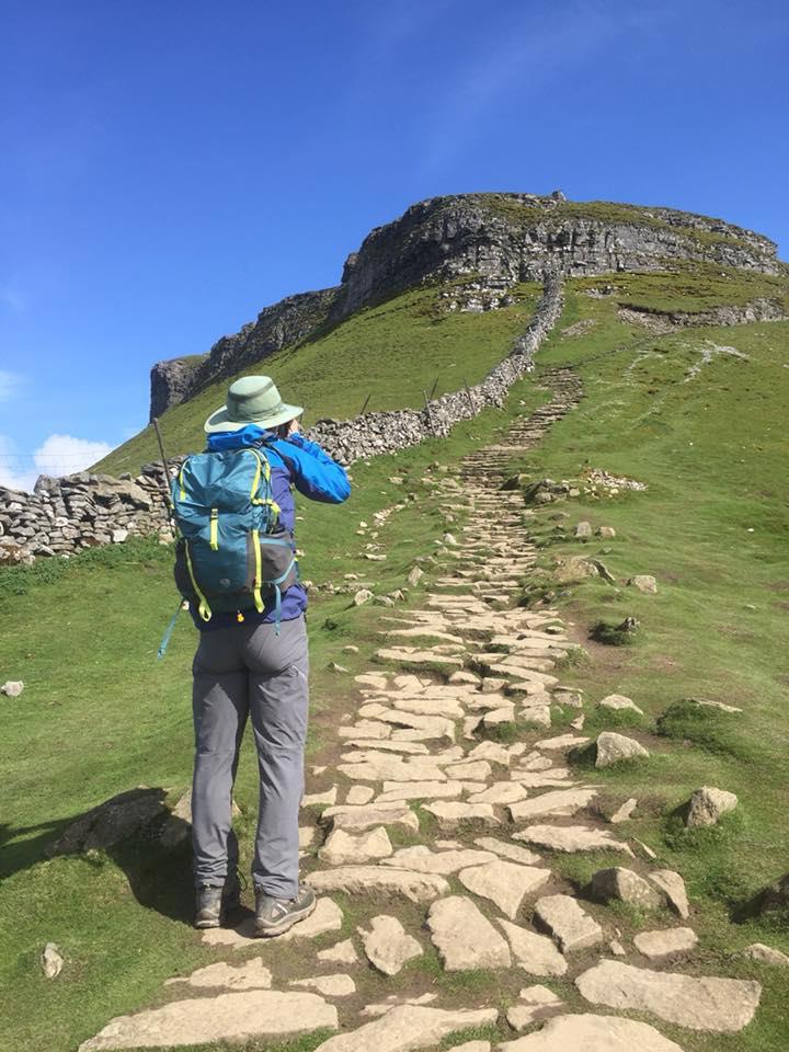 Jiker looking up a big hill with stone path